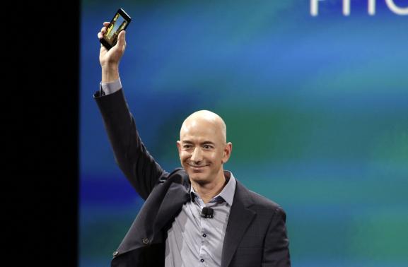 1 OF 3. Amazon CEO Jeff Bezos shows off his company's new smartphone, the Fire Phone, at a news conference in Seattle, Washington June 18, 2014. CREDIT: REUTERS/JASON REDMOND
